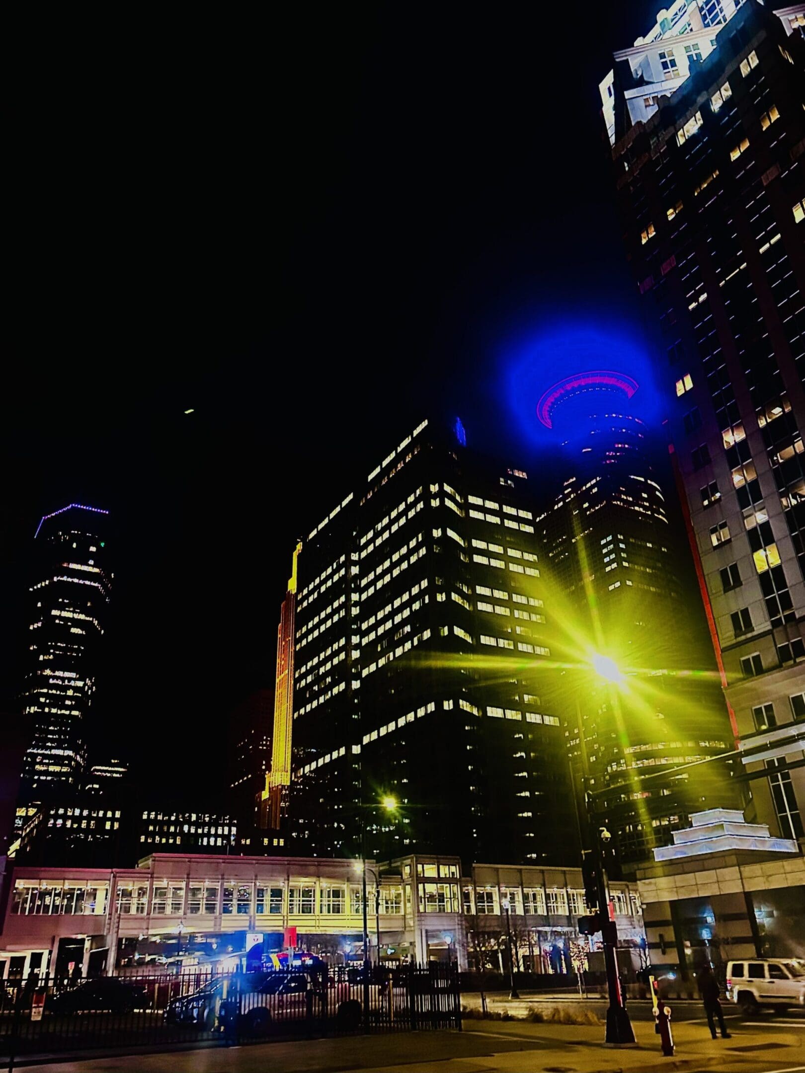 Illuminated skyscrapers under night sky