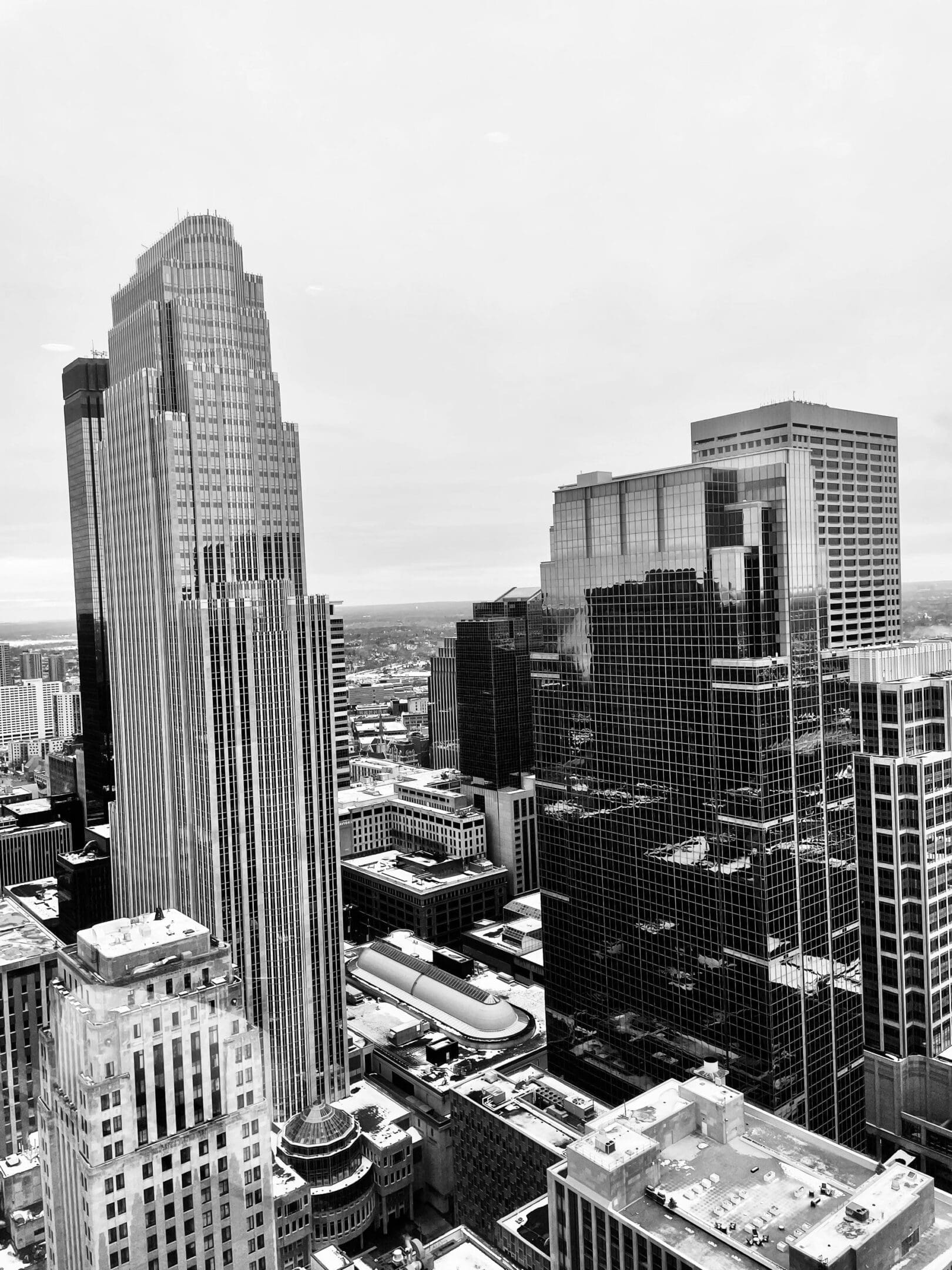 Black and white photo of a city skyline with tall buildings.