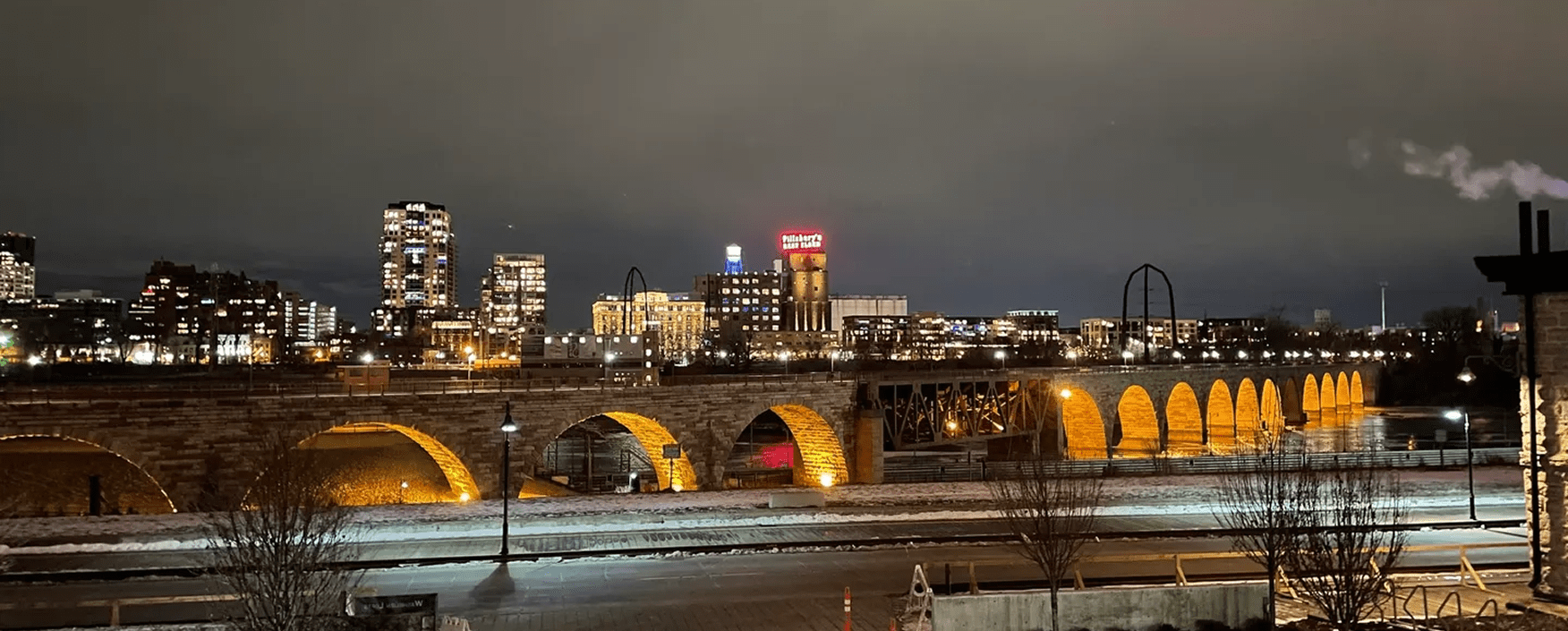 Bridge arches glowing under night sky